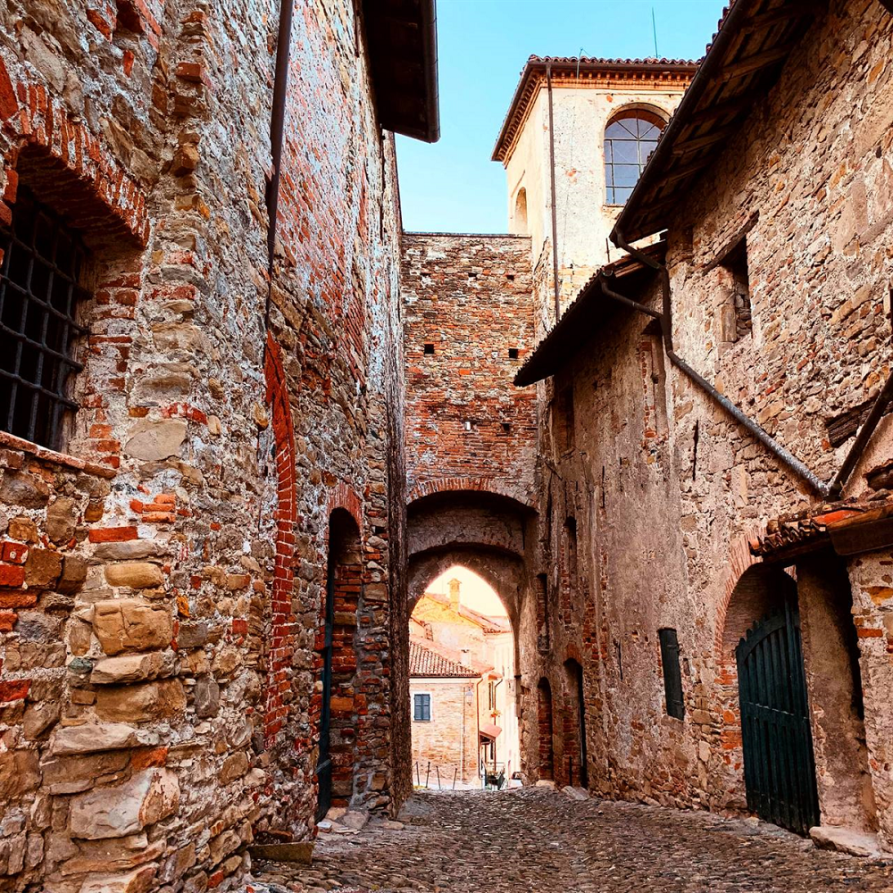Mornese (AL). Edifici storici. Immagine tratta dal sito del Comune. Via con edifici storici di probabile epoca medievale in mattoni rossi 