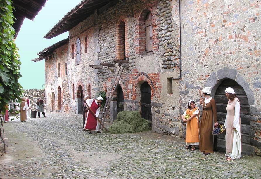 Candelo (BI). Il Ricetto. La via lastricata in ciottoli è animata da figuranti vestiti a tema medievale 