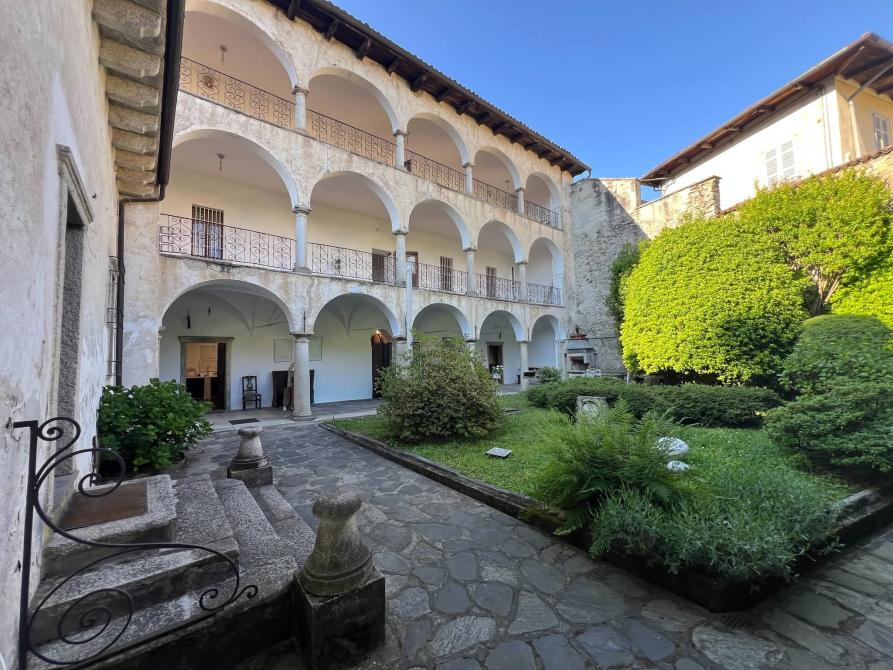 Ameno (NO). Cortile interno della Fondazione Calderara con aiuola verde. Fotografia di Mauriliano Castiglioni (2026)  
